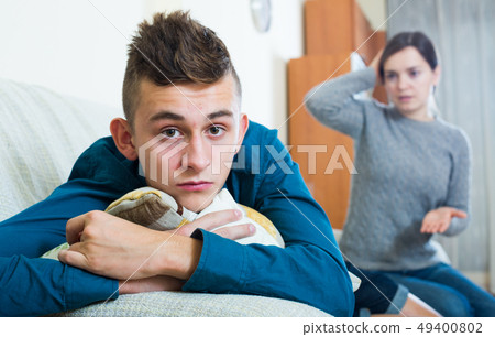 Mother and teenager son having fight at home Mother and teenager son having fight at home 49400802
