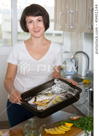 Housewife cooking dorado fish Housewife cooking dorado fish 49401144