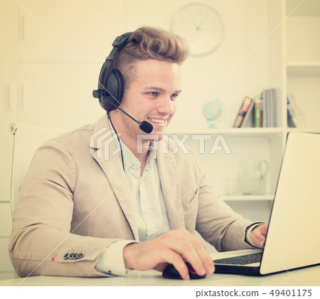 Young man working in call centre Young man working in call centre 49401175