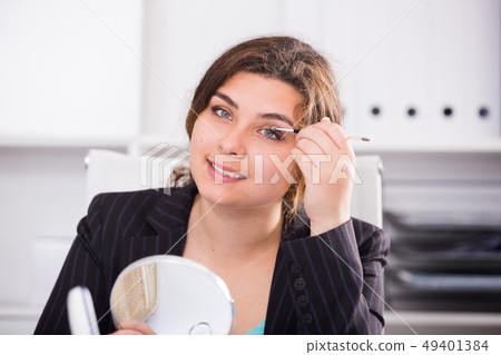 Female trainee is preparing herself for meeting Female trainee is preparing herself for meeting 49401384