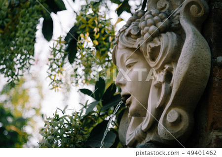 Woman head fountain in the garden Woman head fountain in the garden 49401462