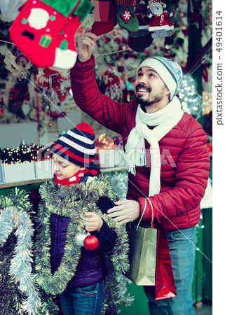 Little girl with dad buying decorations for Xmas 49401614