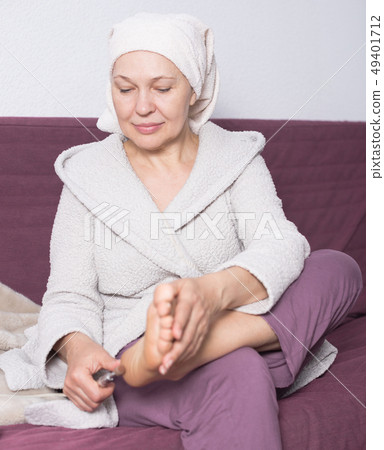 Woman doing pedicure Woman doing pedicure 49401712