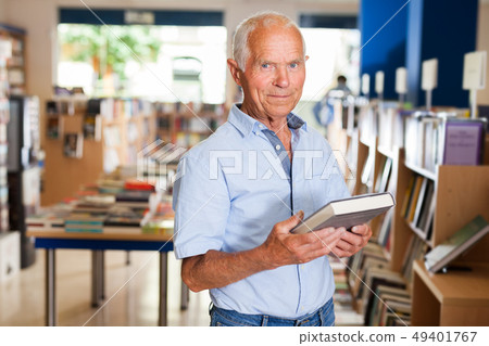 Happy elderly man in bookstore Happy elderly man in bookstore 49401767
