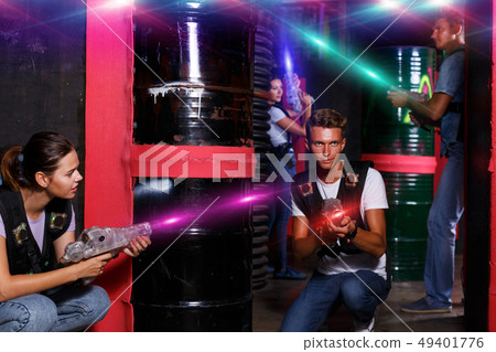 people with laser guns having fun together in dark labyrinth people with laser guns having fun together in dark labyrinth 49401776