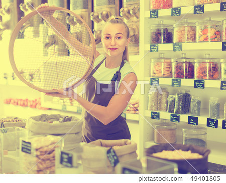 Portrait of girl seller who is standing with ring for grind 49401805