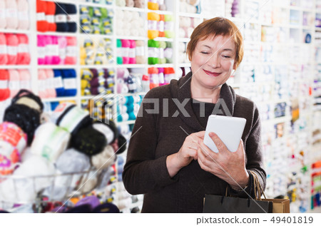 Woman with shopping bags using phone Woman with shopping bags using phone 49401819