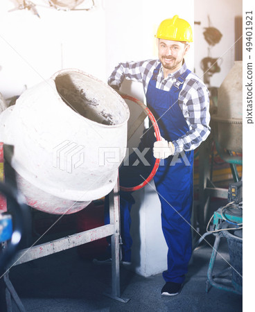 Worker work with cement mixer 49401921