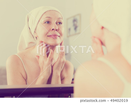 Woman using face cream 49402019
