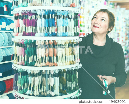 Mature female is buying colorful mouline threads 49402091