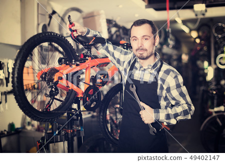 Biker is working on master bicycle assembly 49402147