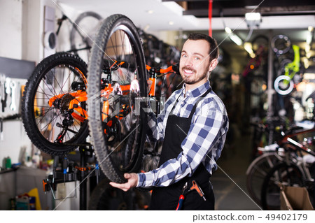 Worker with bicycle wheel 49402179