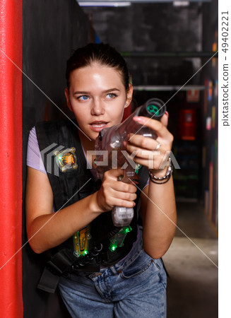 Positive girl took aim during laser tag game 49402221