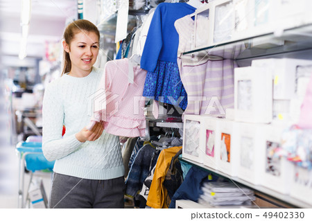 Pretty woman awating for baby and buying clothes Pretty woman awating for baby and buying clothes 49402330