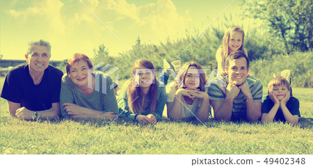 People of different ages taking photos on the lawn People of different ages taking photos on the lawn 49402348