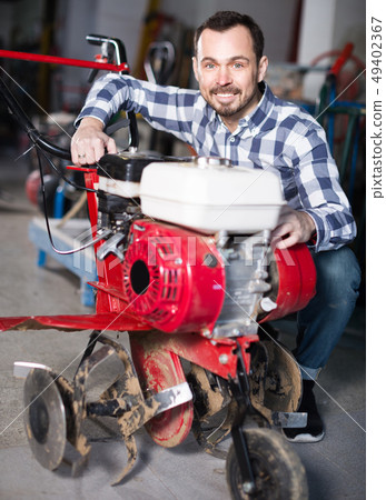 Male 29-35 years old is starting to work with plough 49402367