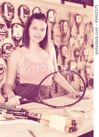 Smiling young girl with racket for tennis Smiling young girl with racket for tennis 49402375