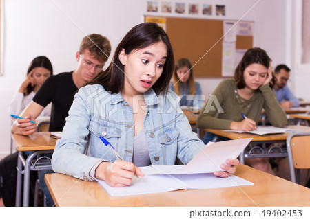 Girl writing test in classroom 49402453
