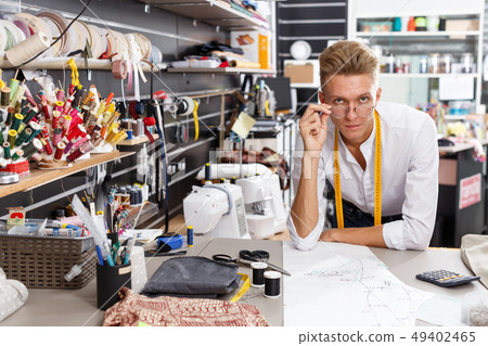 Tailor creating pattern on table 49402465