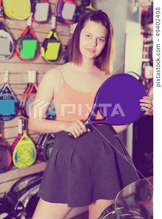 Woman holding professional racket for tennis Woman holding professional racket for tennis 49402498