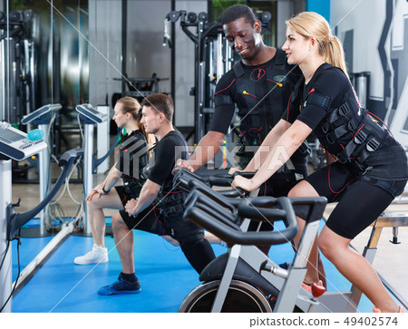 Athletic young people during functional workout with electric muscle stimulation in fitness gym Athletic young people during functional workout with electric muscle stimulation in fitness gym 49402574