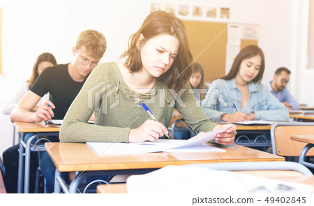 Girl is writing test and answer about task Girl is writing test and answer about task 49402845