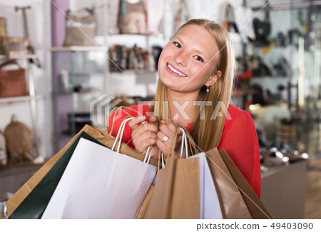 Positive woman customer is demonstrating purchases Positive woman customer is demonstrating purchases 49403090