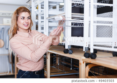 Woman choosing kitchen cabinet in shop 49403503