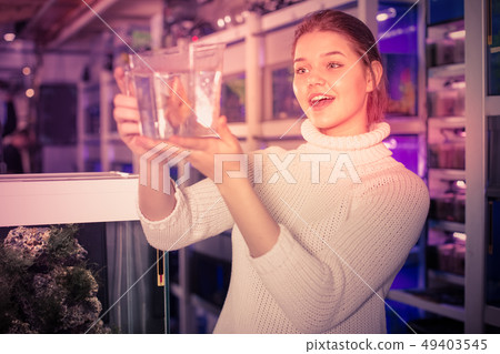 Teen is holding container with water 49403545