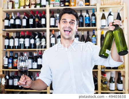 Seller holding bottle of wine Seller holding bottle of wine 49403638