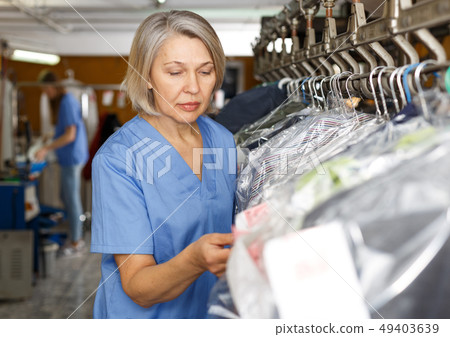 Dry-cleaning salon worker Dry-cleaning salon worker 49403639