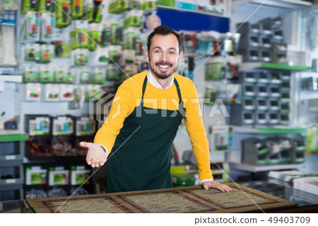 Positive male seller demonstrating assortment Positive male seller demonstrating assortment 49403709