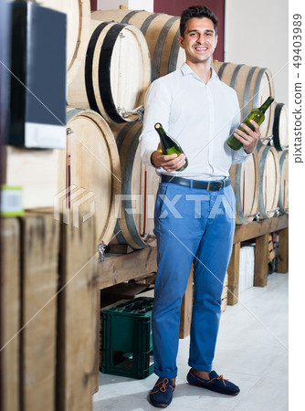 man choosing bottle of wine in shop. 49403989