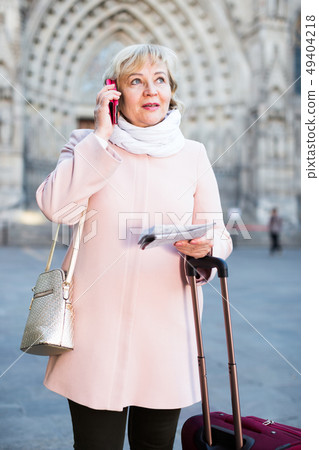 woman with map talking phone woman with map talking phone 49404218