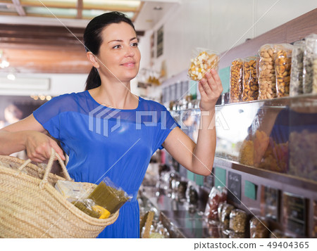 Customer choosing candied fruits Customer choosing candied fruits 49404365