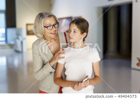 Woman and girl visiting museum Woman and girl visiting museum 49404373