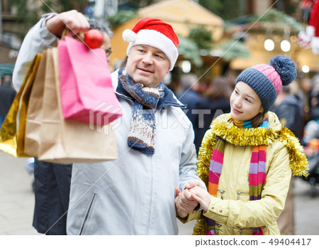 Happy family after shopping on Christmas market Happy family after shopping on Christmas market 49404417