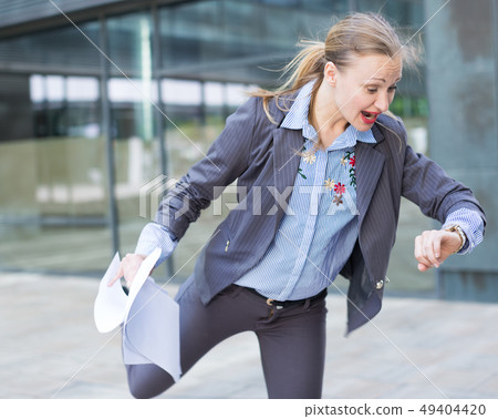 Portrait of busy female rushing to important meeting Portrait of busy female rushing to important meeting 49404420