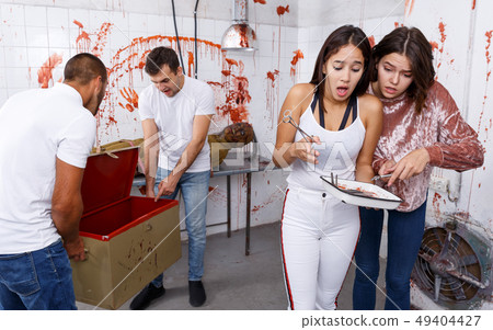 Scared girls with medical instruments in lost room 49404427