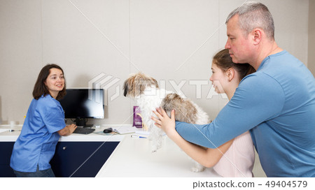 Woman veterinarian with visitors Woman veterinarian with visitors 49404579
