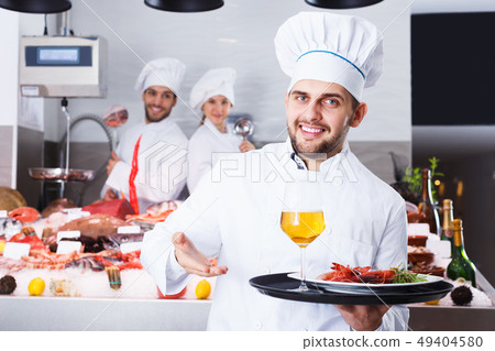 Chef standing in fish restaurant Chef standing in fish restaurant 49404580