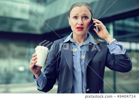 Adult businesswoman talking on the mobile phone Adult businesswoman talking on the mobile phone 49404714