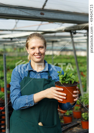 Female farmer posing in glasshouse Female farmer posing in glasshouse 49404715