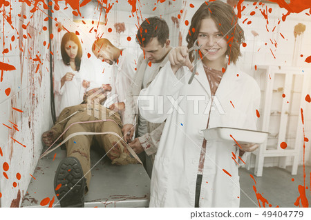 Happy girls in quest room with bloody traces 49404779