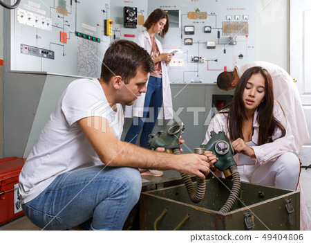 Girl and guy with box in escape room Girl and guy with box in escape room 49404806