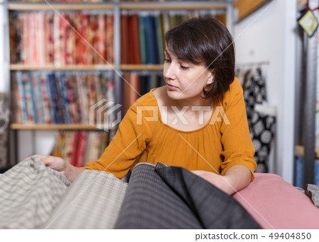 Woman looking for cloth in shop Woman looking for cloth in shop 49404850