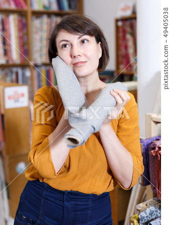 Brunette touching face with fabric Brunette touching face with fabric 49405038
