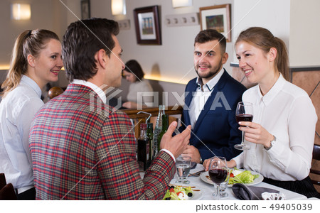 Friends having dinner at restaurant Friends having dinner at restaurant 49405039