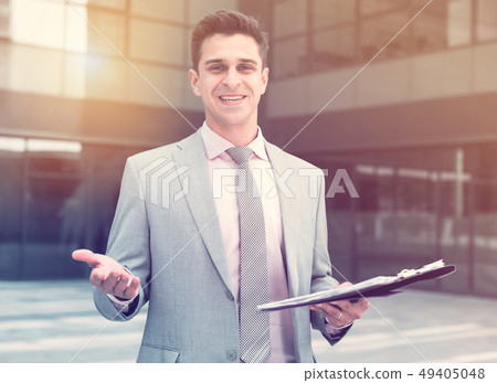 Smiling businessman welcoming partners Smiling businessman welcoming partners 49405048