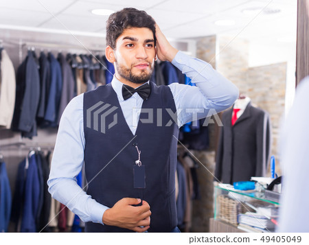 Customer is trying on chosen image in front of the mirror Customer is trying on chosen image in front of the mirror 49405049